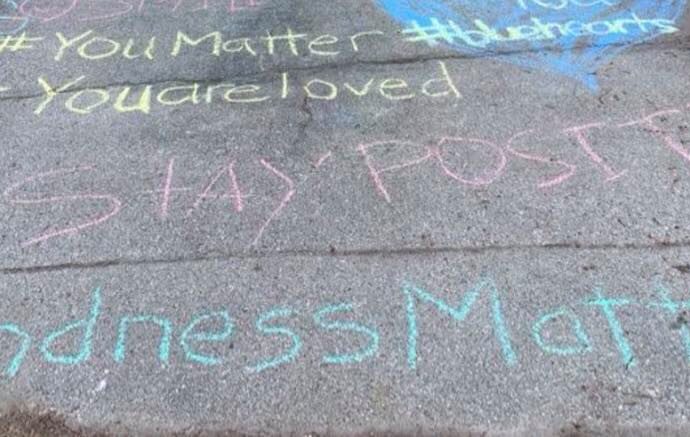 Chalk writing on sidewalk "Kindness Matters"