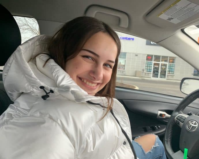 Tori Illman smiling while sitting in her car