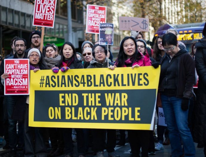 protestors with #Asians4BlackLives sign