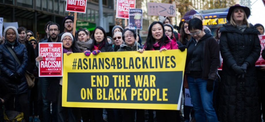 protestors with #Asians4BlackLives sign