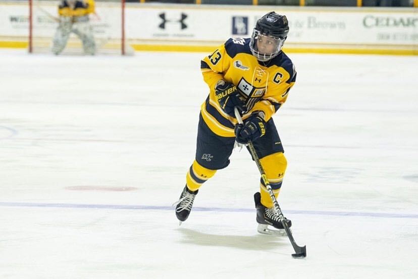 Action shot of playing hockey at Mikyla Grant-Mentis at Merrimack College