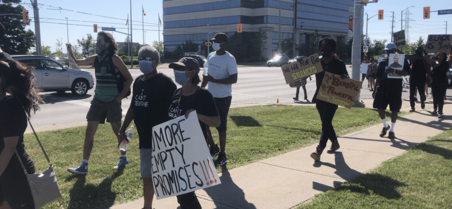 Individuals marching for reform in the PDSB after complaints about racism and discrimination