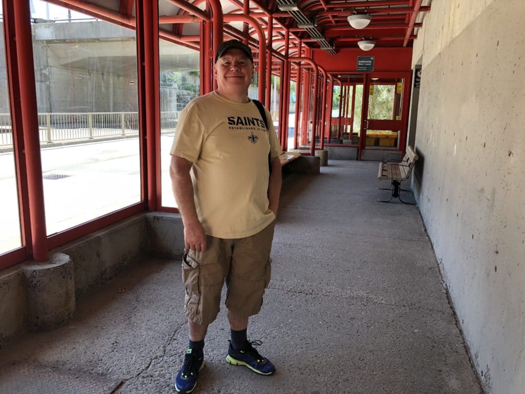 Photo of Anotoliy Borodavka standing in the bus shelter, without a mask on.