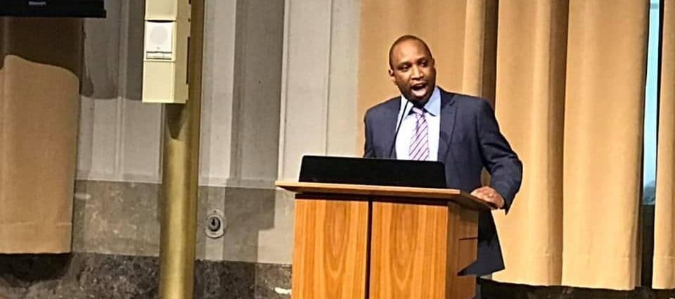 A photo of Councilor Rawlson King speaking at an event.
