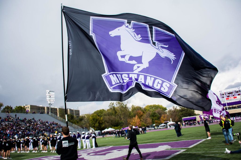 Large crowds and waving flags at TD stadium in support of Western Mustangs football