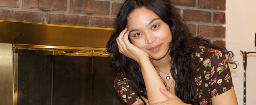 A photo of KYN Founder, Dana Bryce, in front of a fireplace