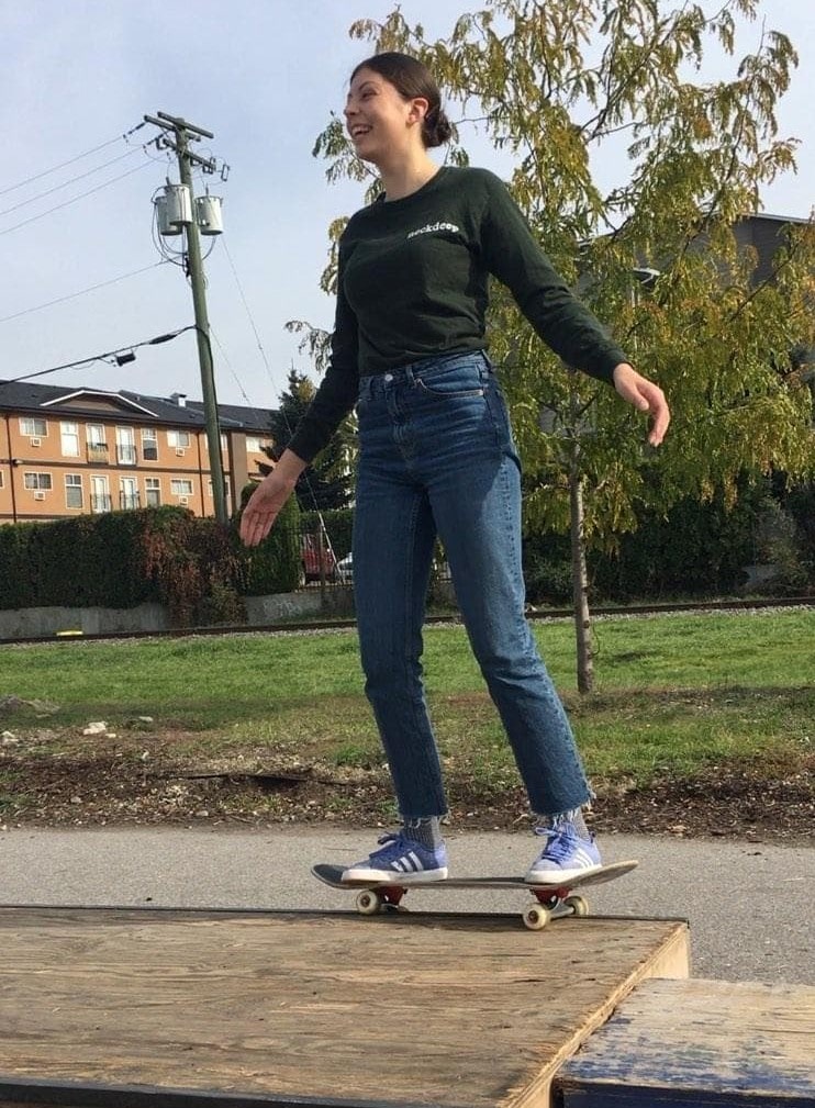 A picture of skateboarder Ciara Wilson landing a 50 50 skate trick
