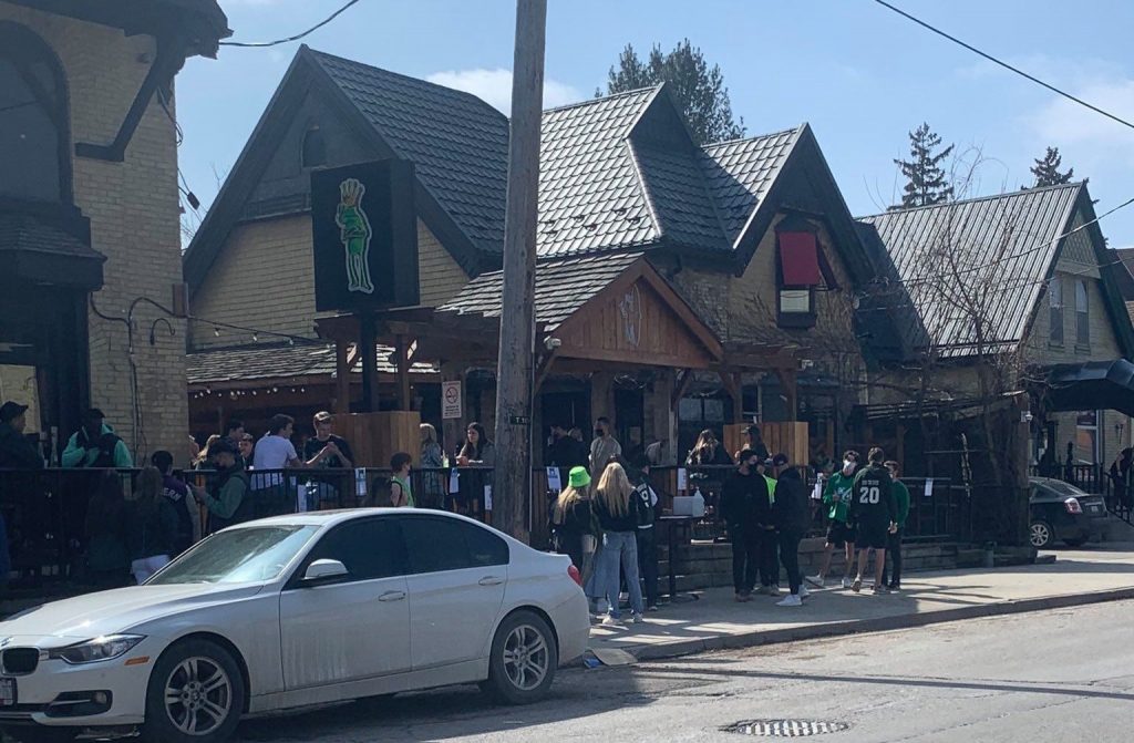 People line up outside bars on Richmond Row in London, Ont.